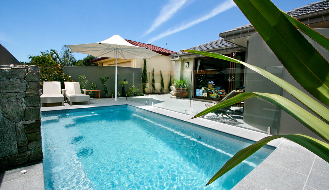 Leisure Pools Harmony fiberglass swimming pool with perimeter safety ledge