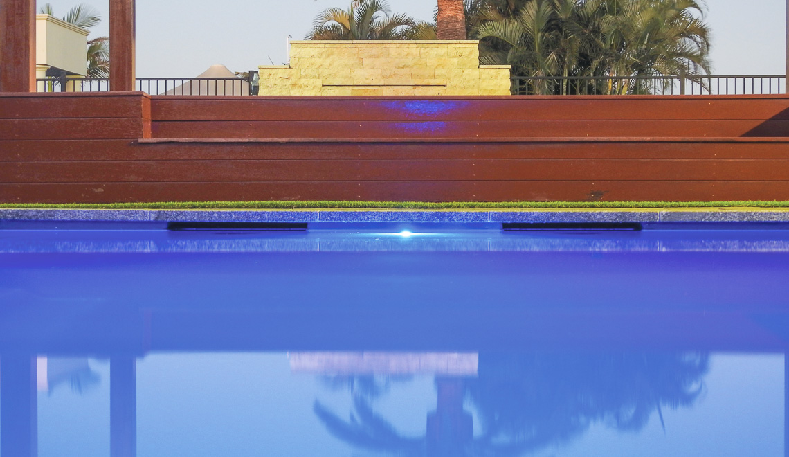 Leisure Pools Precision fiberglass swimming pool with built-in splash deck